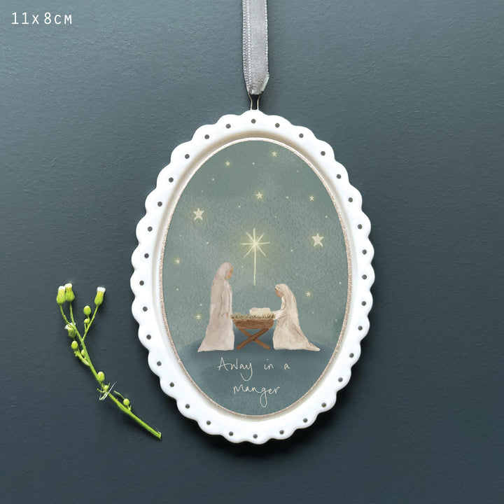 Porcelain Christmas Tree Decoration, Away in a Manger | East of India Hanging Decoration East of India Porcelain Scallop Oval Christmas Tree Decoration - Away in a Manger